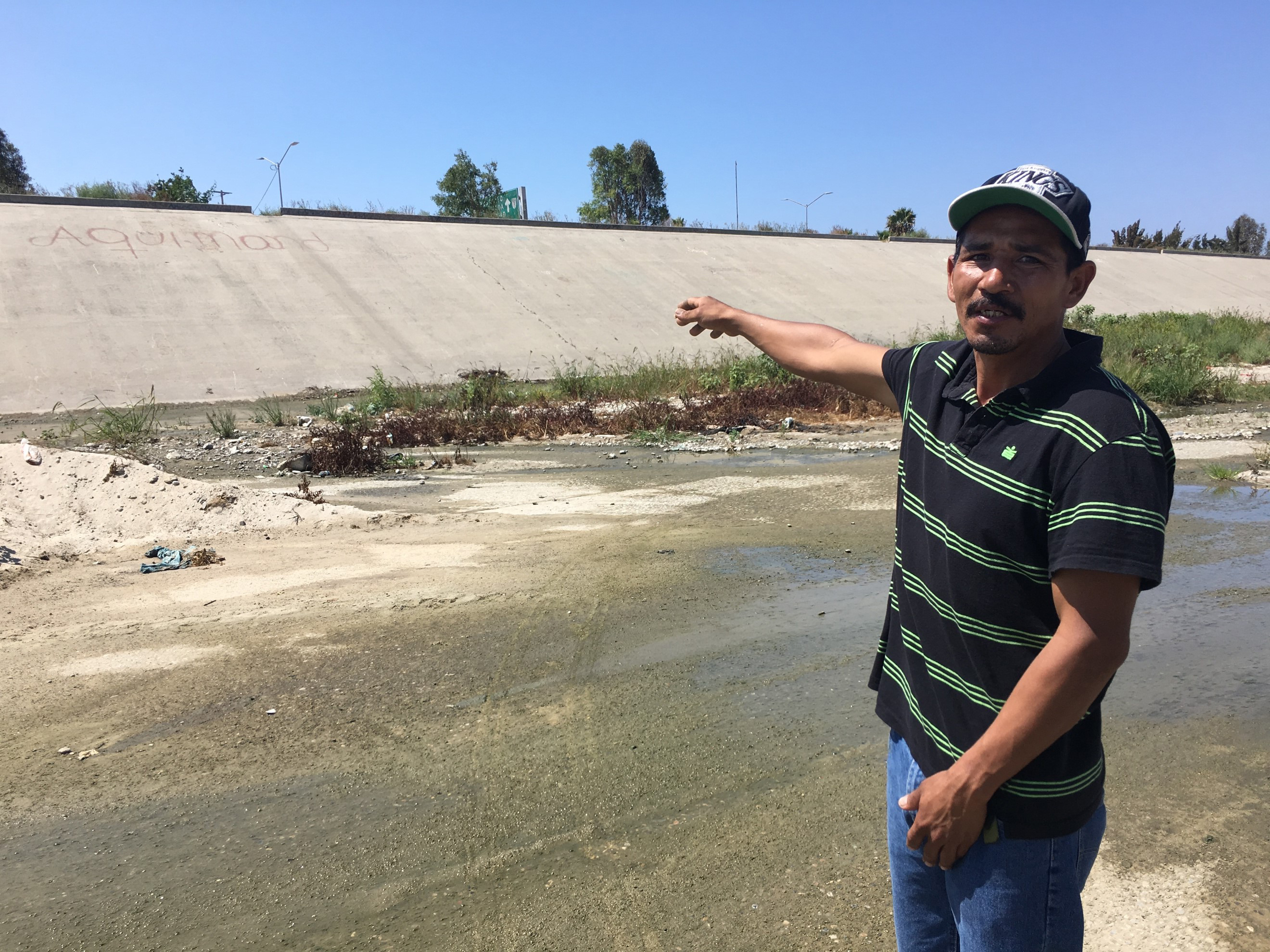 Guadalupe Mendívil pointing to a site where he’d lived in a homeless camp in El Bordo