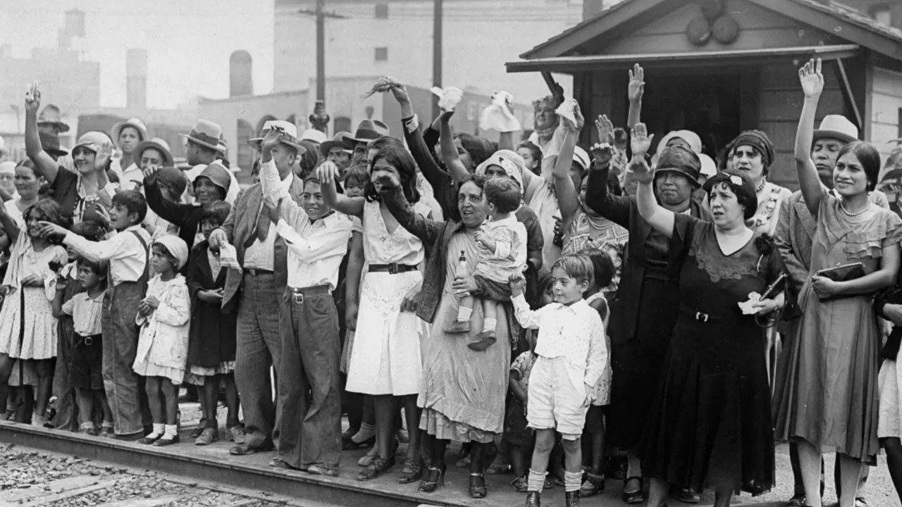 Relatives and friends wave goodbye to a train carrying 1,500 persons being expelled from Los Angeles back to Mexico on Aug. 20, 1931. Photo via NY Daily News Archive, Getty Images
