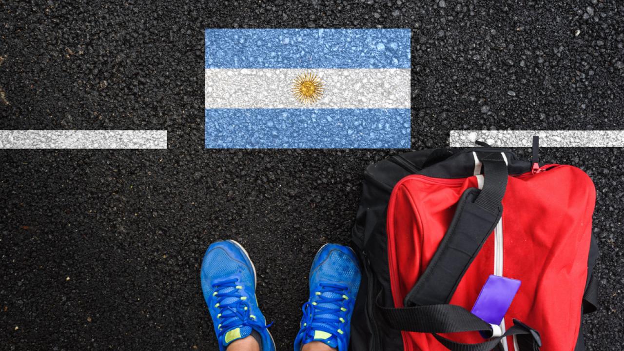 Argentina Flag on Pavement at the feet of an arriving traveler