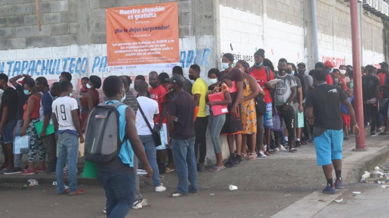 Haitian migrants waiting in line 