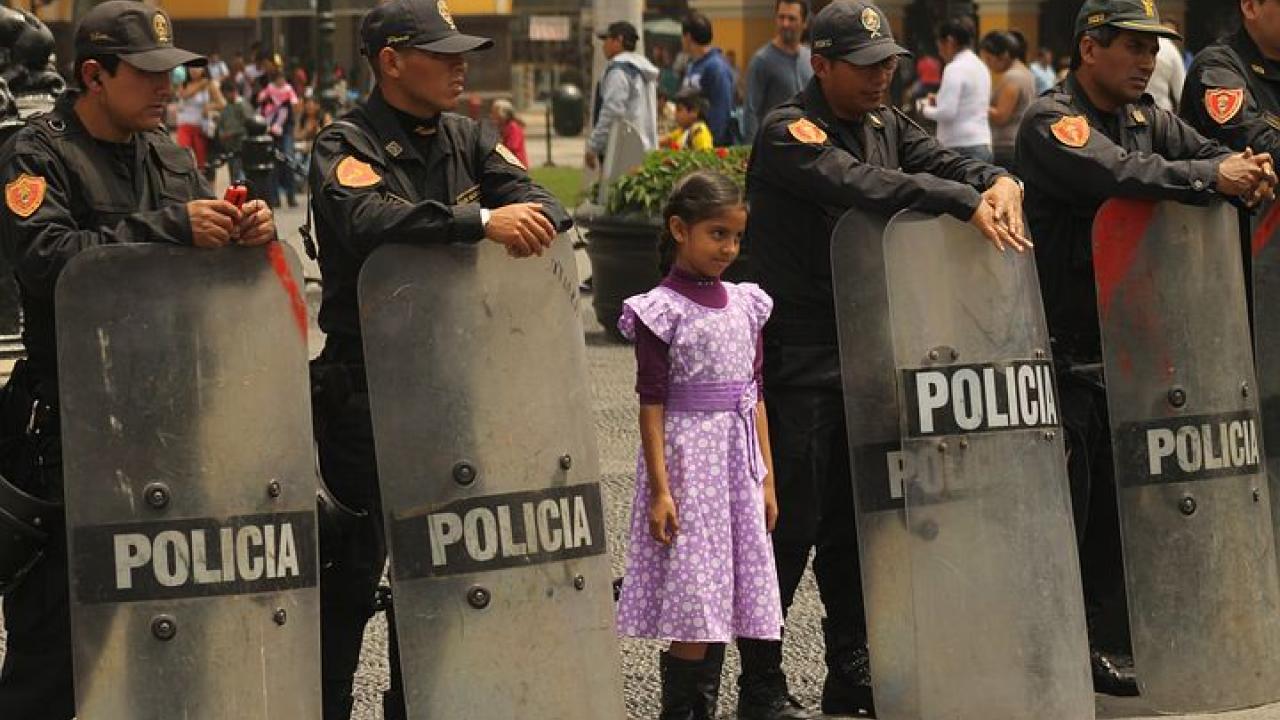 Stock Photo of a young girl surrounded by riot police