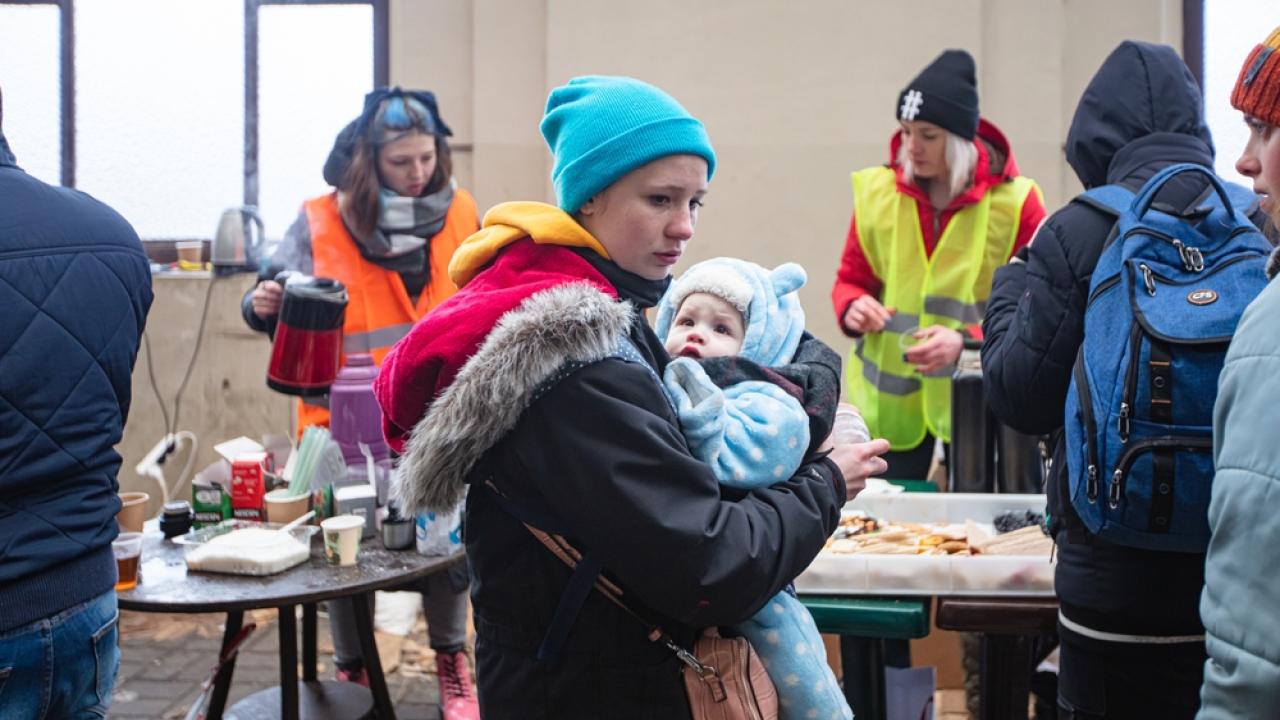 Ukrainian Mother holding baby as she receives aide