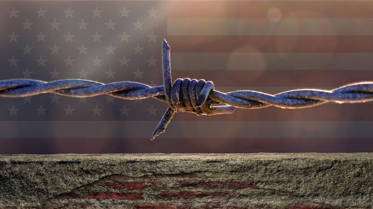 american flag behind twisted wire