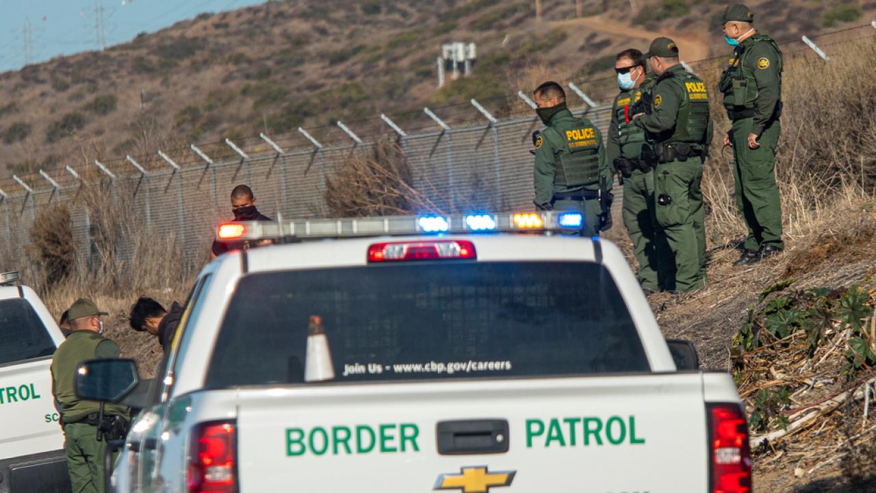 Border Patrol Cars Detaining a Person
