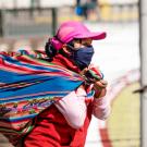 Mexican Woman Wearing a Mask Carrying a Bag