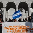 A protester waves a Salvadoran flag as people protest in front of Los Angeles City Hall against federal immigration operations on June 11, 2025. Protests against Donald Trump's harsh immigration policies spread on June 11 across the United States.