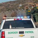 Border Patrol Cars Detaining a Person